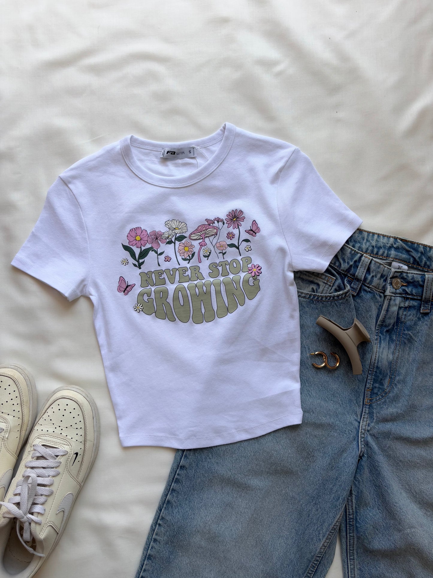 'Never stop growing' baby tee
