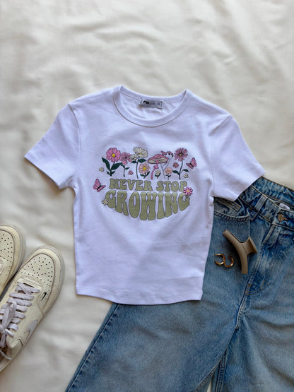 'Never stop growing' baby tee