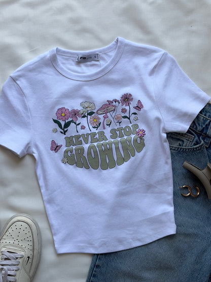 'Never stop growing' baby tee