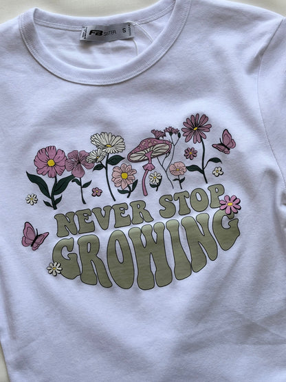 'Never stop growing' baby tee